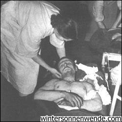A wounded Russian is treated by a Finnish nurse 
in a field hospital